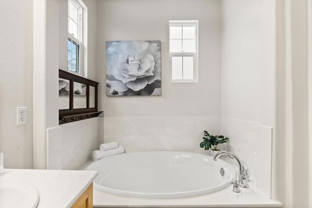 bathroom with a tub to relax in and vanity