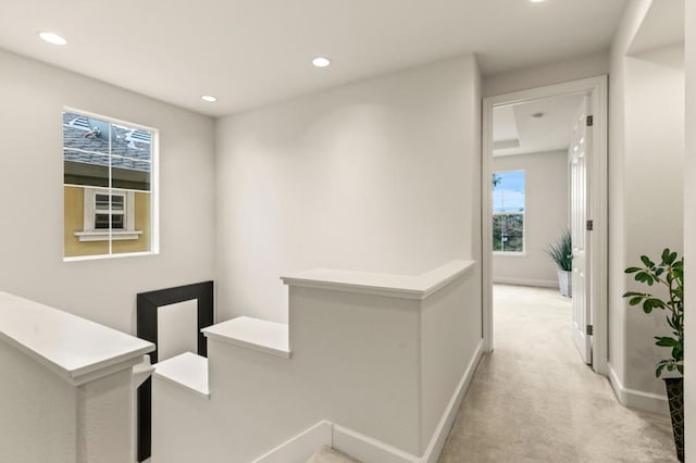 corridor with light colored carpet and plenty of natural light