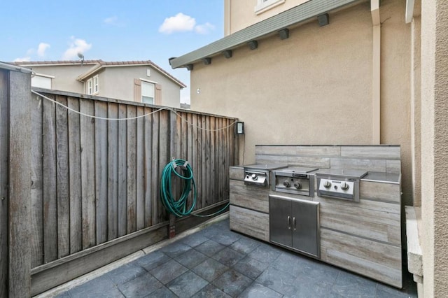 view of patio featuring an outdoor kitchen