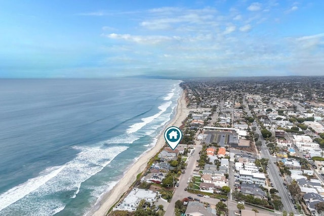 drone / aerial view with a water view and a beach view