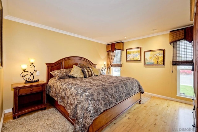 bedroom featuring crown molding and light hardwood / wood-style floors