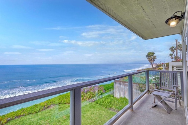 balcony featuring a water view and a view of the beach