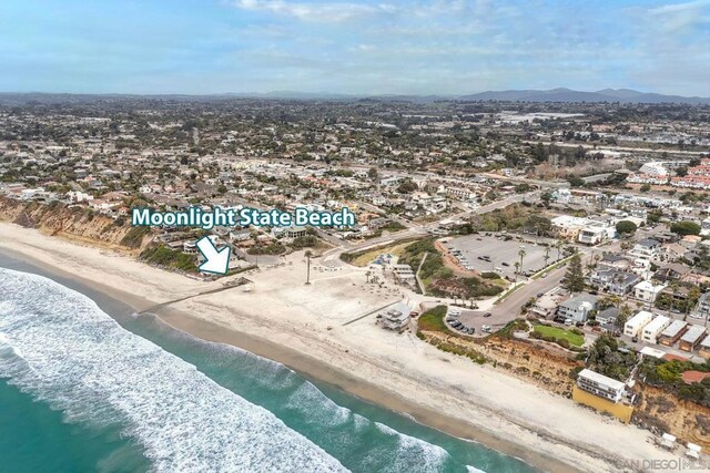 aerial view featuring a view of the beach and a water view