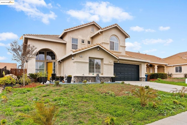 mediterranean / spanish house featuring a garage and a front yard