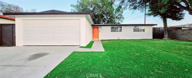 single story home with a garage and a front lawn