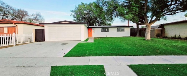 single story home featuring a garage and a front yard