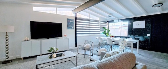 living room featuring a wealth of natural light and lofted ceiling with beams