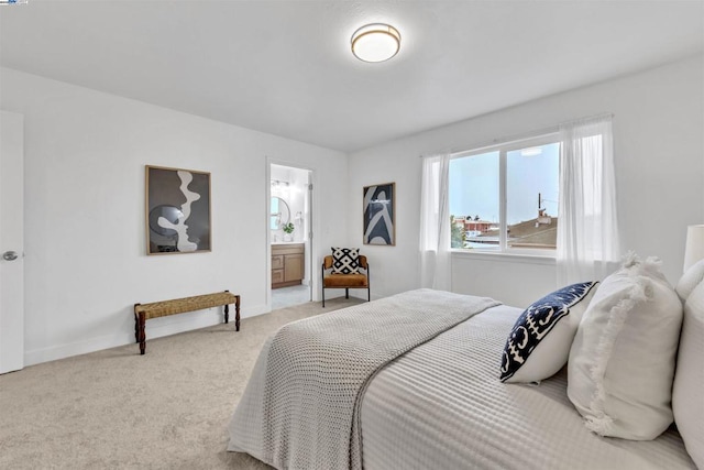 carpeted bedroom featuring connected bathroom