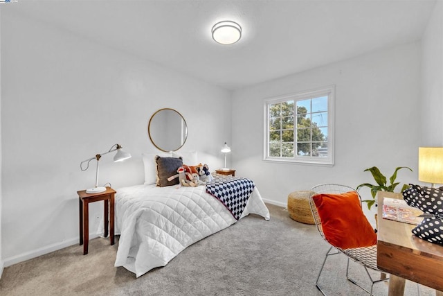 bedroom featuring light colored carpet