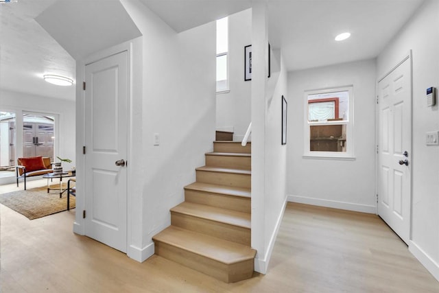 stairway with hardwood / wood-style flooring