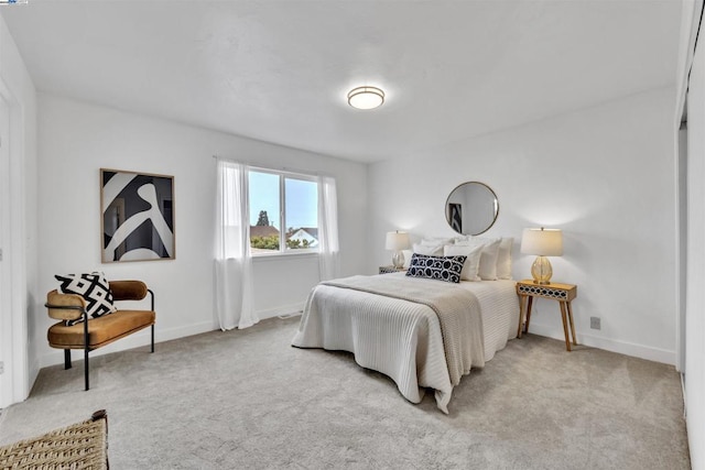 bedroom featuring light carpet