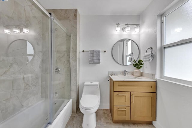 full bathroom with bath / shower combo with glass door, vanity, and toilet