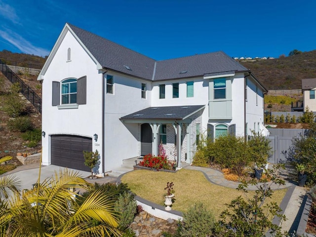 view of front of property featuring a garage and a front yard