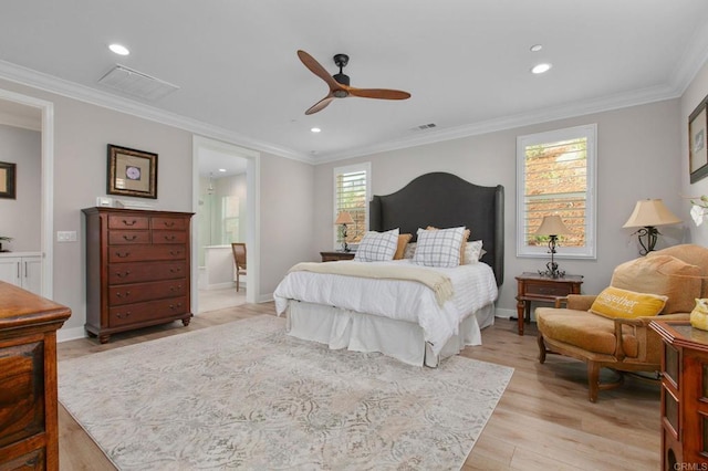 bedroom featuring ceiling fan, ornamental molding, connected bathroom, and light hardwood / wood-style floors