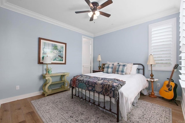 bedroom with ornamental molding, wood-type flooring, and ceiling fan