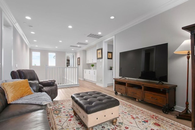 living room with crown molding and light hardwood / wood-style flooring