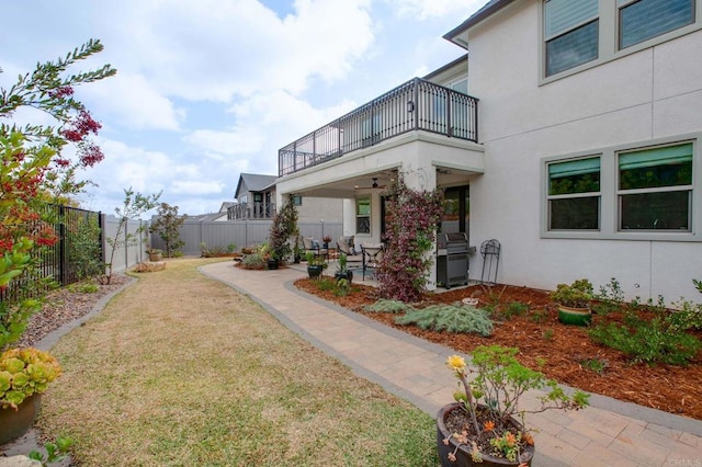 view of yard featuring a patio area and a balcony