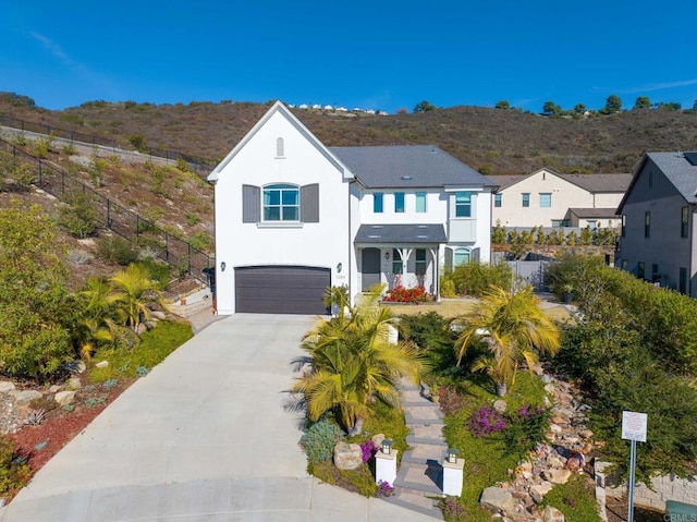 view of front of property with a garage and a mountain view