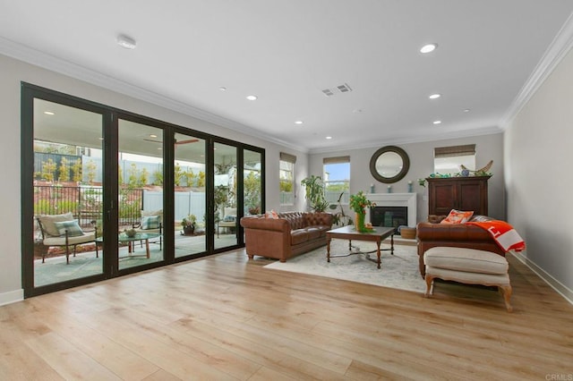 living room featuring crown molding and light hardwood / wood-style flooring