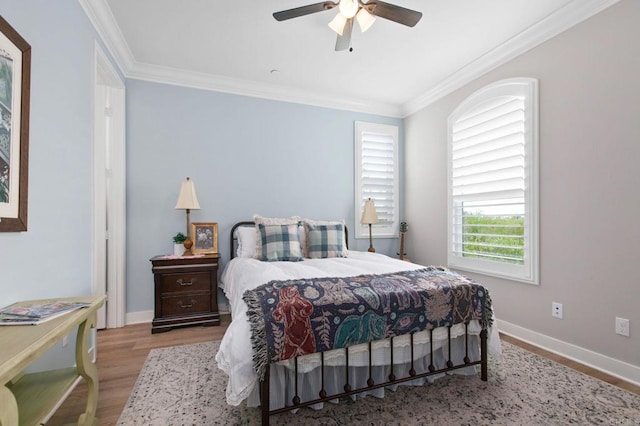 bedroom with crown molding, ceiling fan, and light wood-type flooring