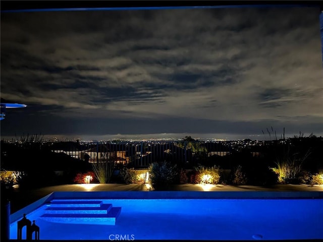 view of pool at night