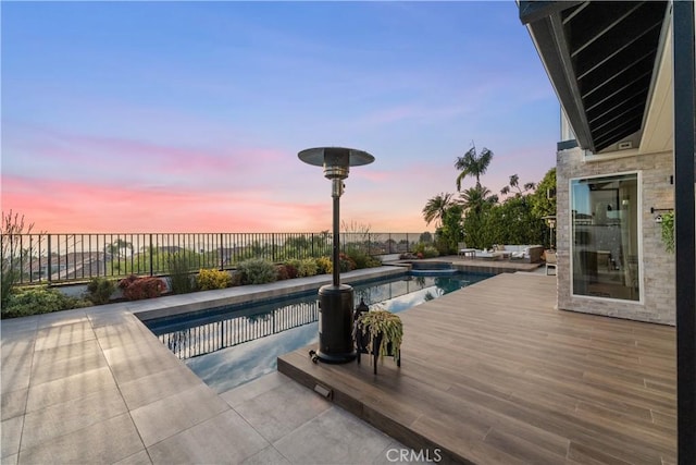 pool at dusk with a deck