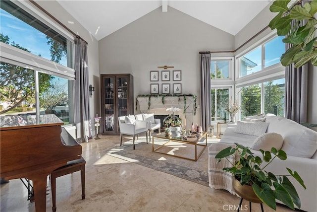 living room featuring beamed ceiling and high vaulted ceiling