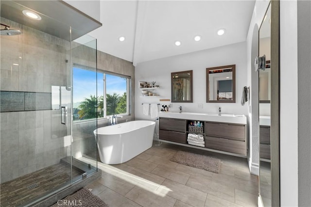 bathroom with vanity, lofted ceiling, and separate shower and tub