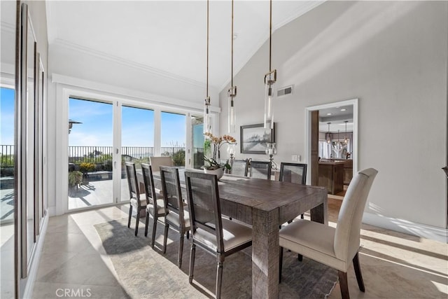 dining space featuring crown molding and high vaulted ceiling