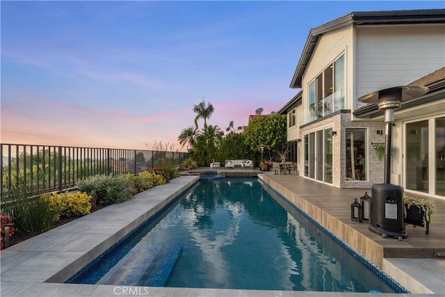 view of pool at dusk