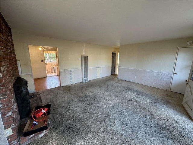 unfurnished living room with carpet floors and ceiling fan