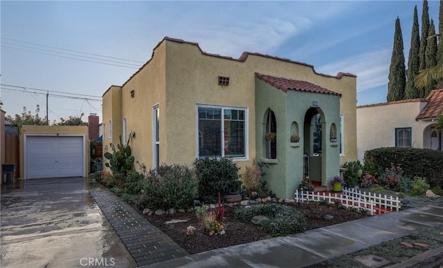 mediterranean / spanish home featuring a garage