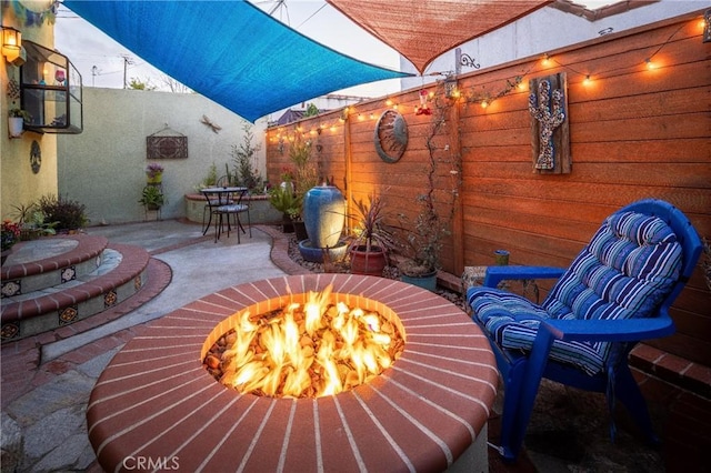 view of patio with a fire pit and fence