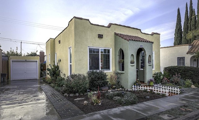 mediterranean / spanish home with an outbuilding, a tile roof, and stucco siding