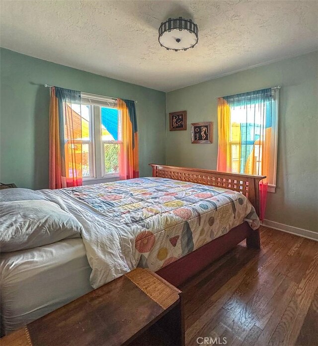 1425 Russell Dr, Long Beach, CA 90804 - bedroom featuring wood finished floors, a textured ceiling, and baseboards