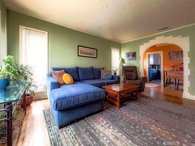 1425 Russell Dr, Long Beach, CA 90804 - living room with arched walkways, wood finished floors, and healthy amount of natural light