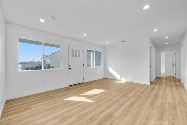 unfurnished living room with light wood-type flooring