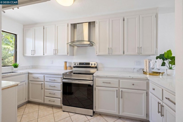 kitchen with light tile patterned flooring, sink, ventilation hood, stainless steel electric range, and white cabinets