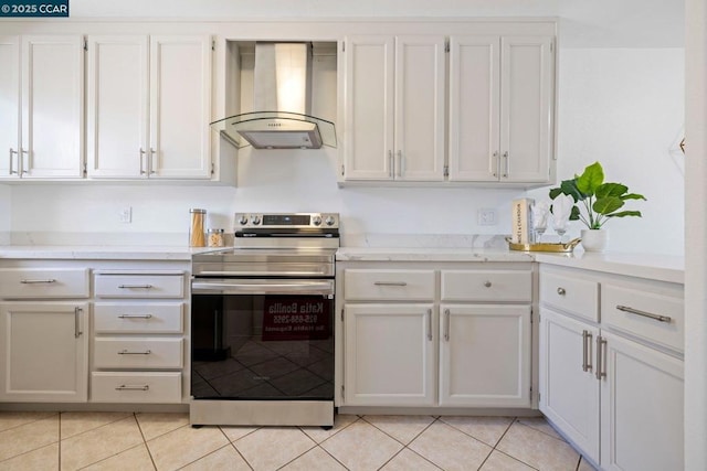 kitchen with light tile patterned flooring, white cabinets, stainless steel electric stove, and exhaust hood