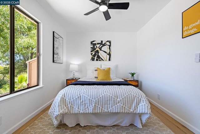 bedroom with hardwood / wood-style flooring and ceiling fan