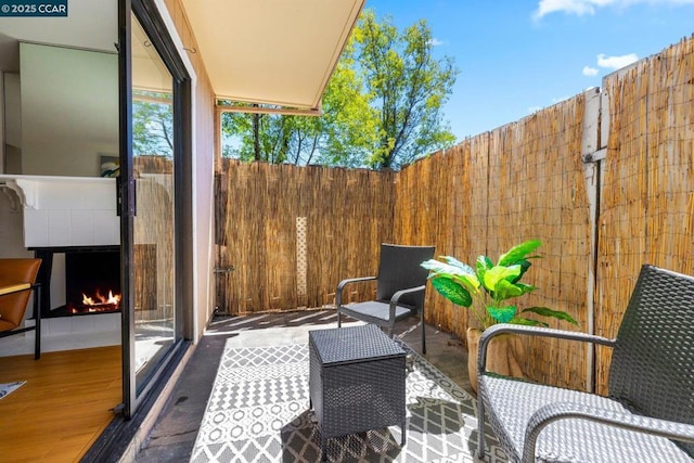 view of patio / terrace with exterior fireplace