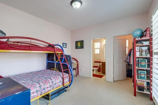 carpeted bedroom with ensuite bath