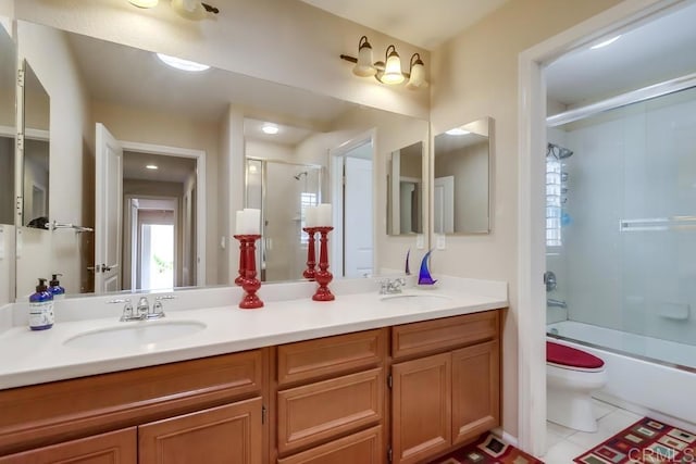 full bathroom featuring vanity, tile patterned flooring, toilet, and combined bath / shower with glass door