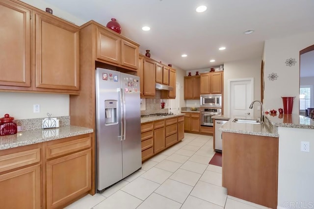 kitchen featuring sink, decorative backsplash, light stone countertops, and appliances with stainless steel finishes