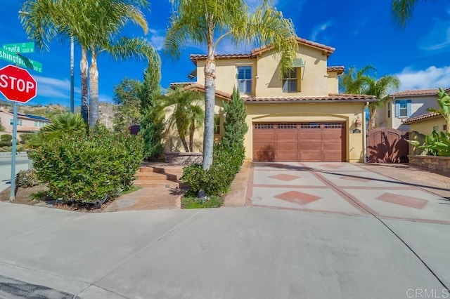 mediterranean / spanish-style house with a garage