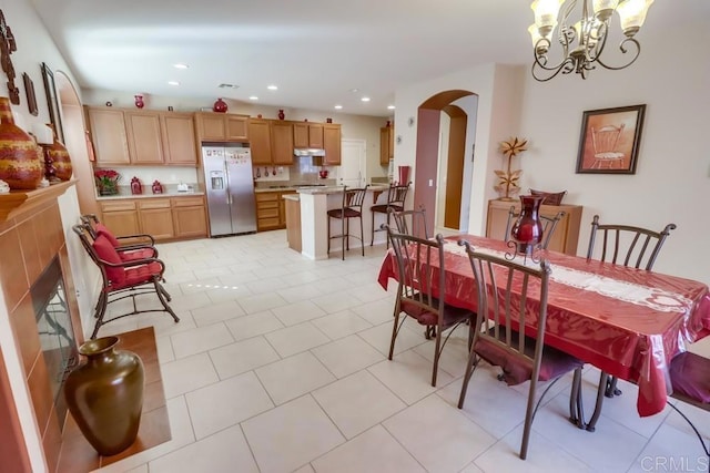 tiled dining area with a notable chandelier