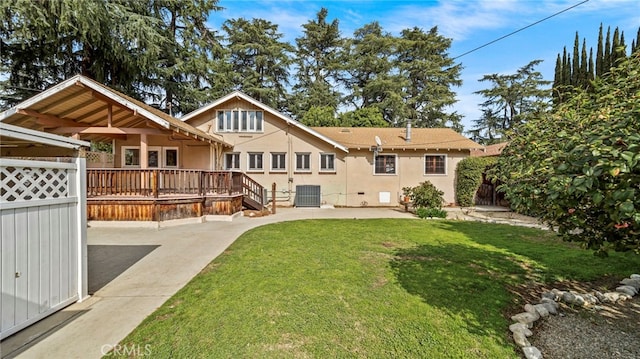 back of property featuring central AC unit, a yard, and a wooden deck