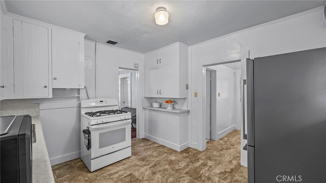 kitchen with white cabinetry, white range with gas stovetop, and stainless steel refrigerator