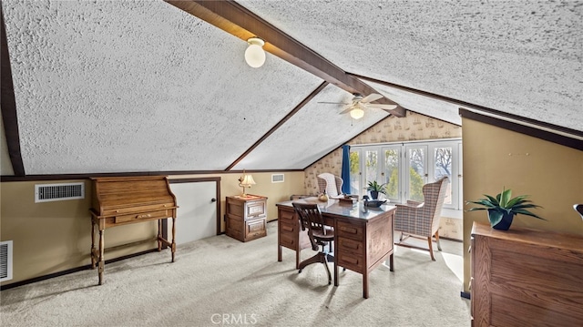 home office featuring ceiling fan, vaulted ceiling with beams, a textured ceiling, and carpet flooring