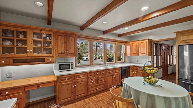 kitchen with stainless steel appliances, beam ceiling, sink, and decorative backsplash